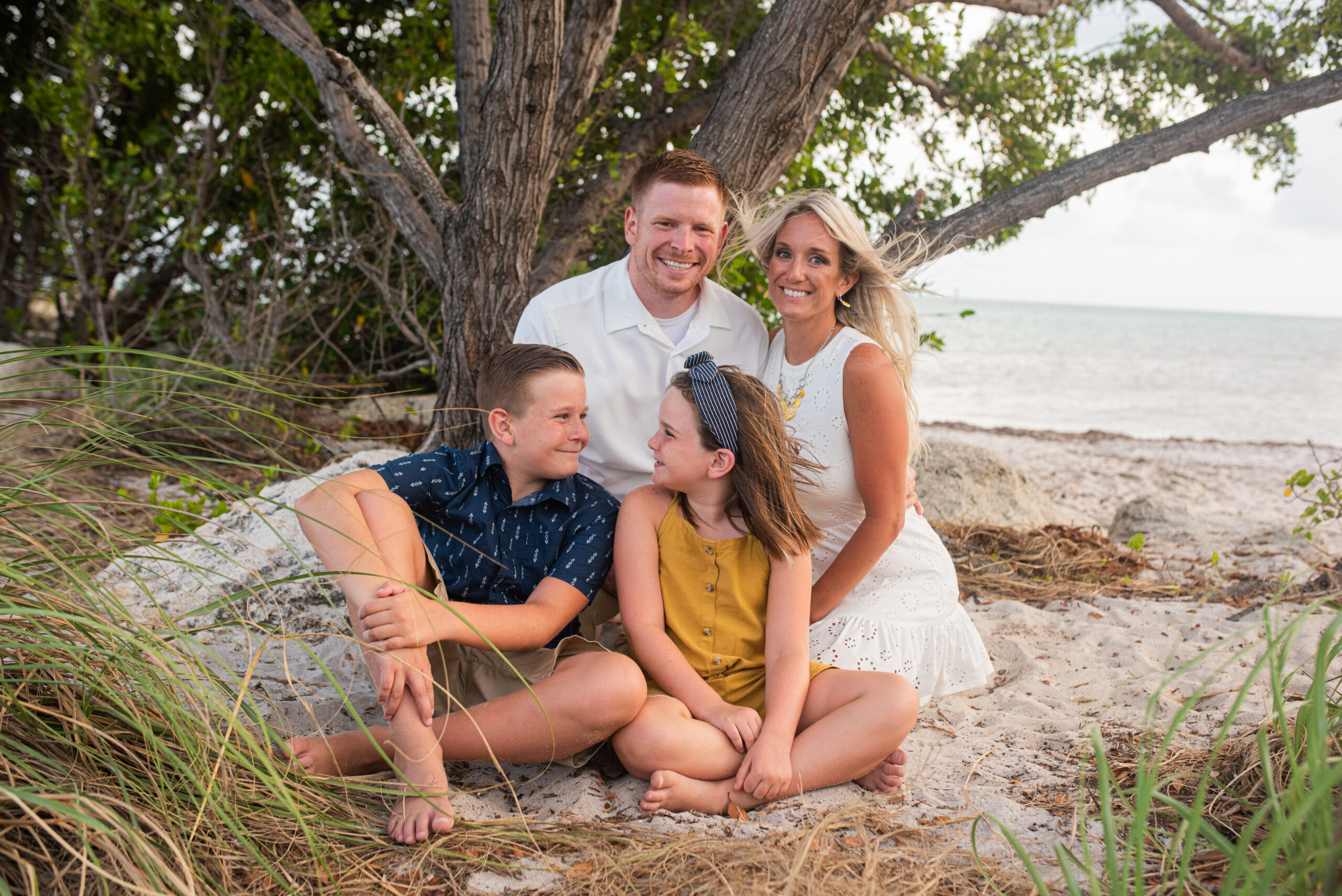 Family poses in the shade as Key West Photographer takes pictures at Smathers Beach