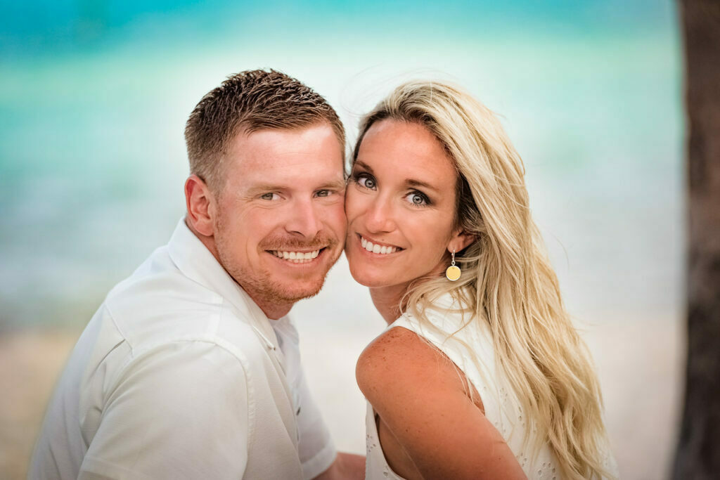 Key West couple poses at Smathers Beach with big smiles